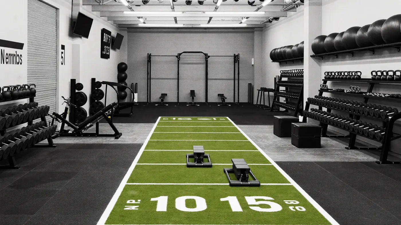 Members training in a hyrox-style gym (AI-generated visual)
